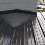 Sunlight glistening off of a black metal roof.
