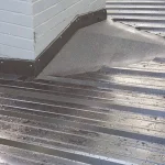 Sunlight glistening off of a black metal roof.