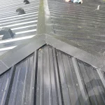 Sunlight glistening off of a black metal roof.