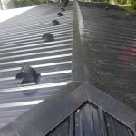 Sunlight glistening off of a black metal roof.