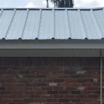White metal roof on a brick single story home.