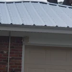 White metal roof on a brick single story home.