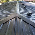 Sunlight glistening off of a black metal roof.